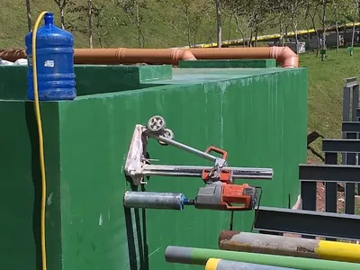Perfuração horizontal em parede de reservatório de água para entrada de tubulação